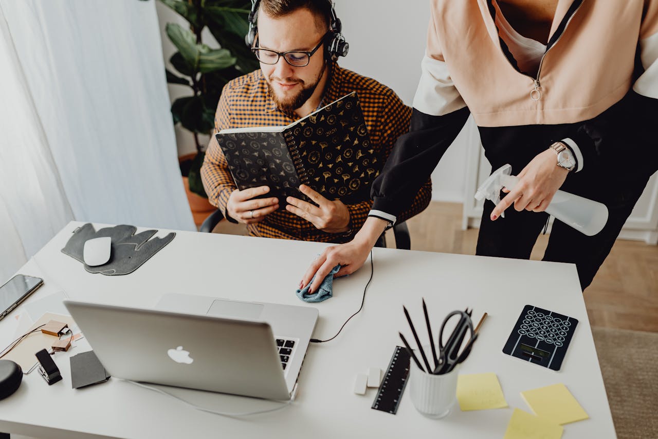 Colleagues interact in a modern office setting, blending technology with workplace hygiene.